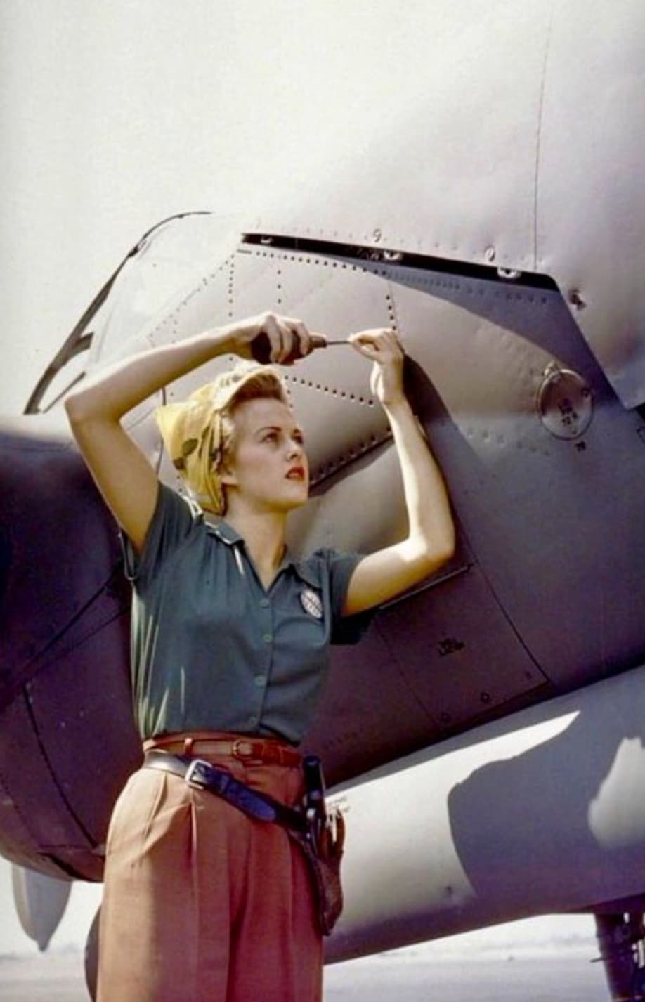 “A female Lockheed employee works on a P-38 Lightning, Burbank, CA, 1944."